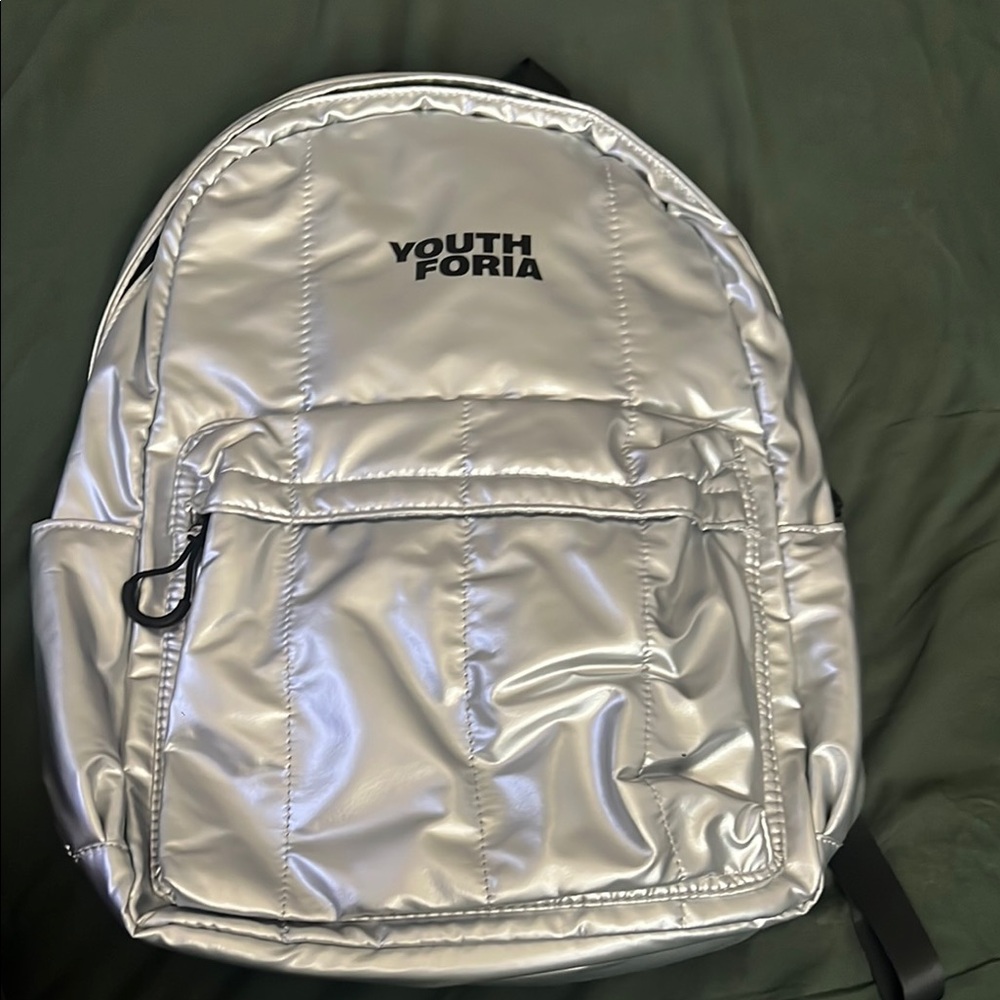 Sleek Silver Backpack with Reflective Finish and Modern Design